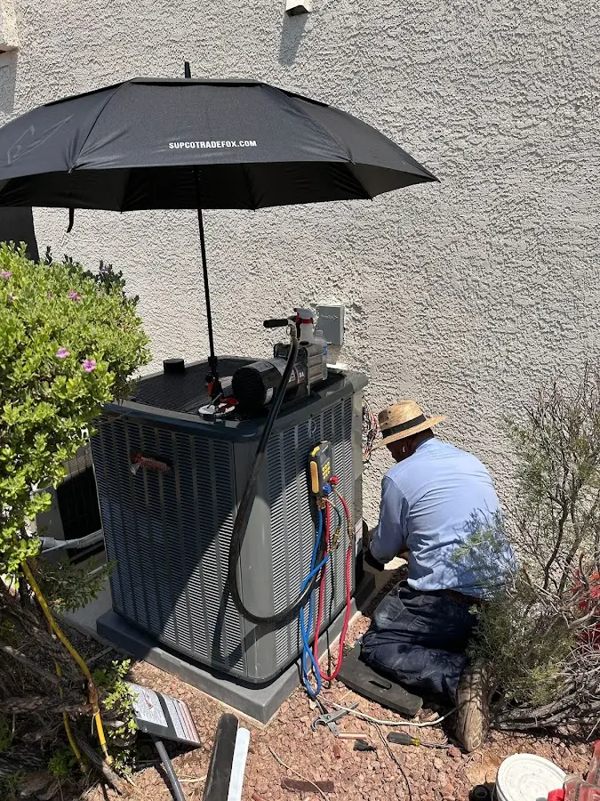 HVAC technician performing outdoor AC maintenance in Chanceford